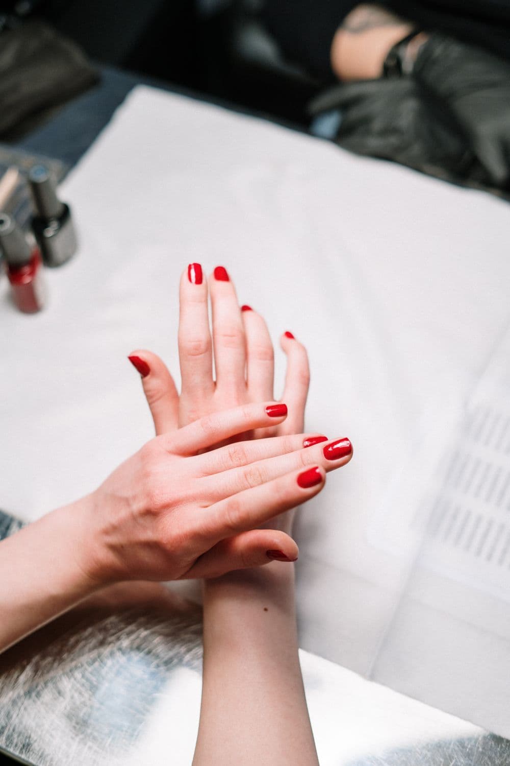 A fresh red gel manicure on two hands